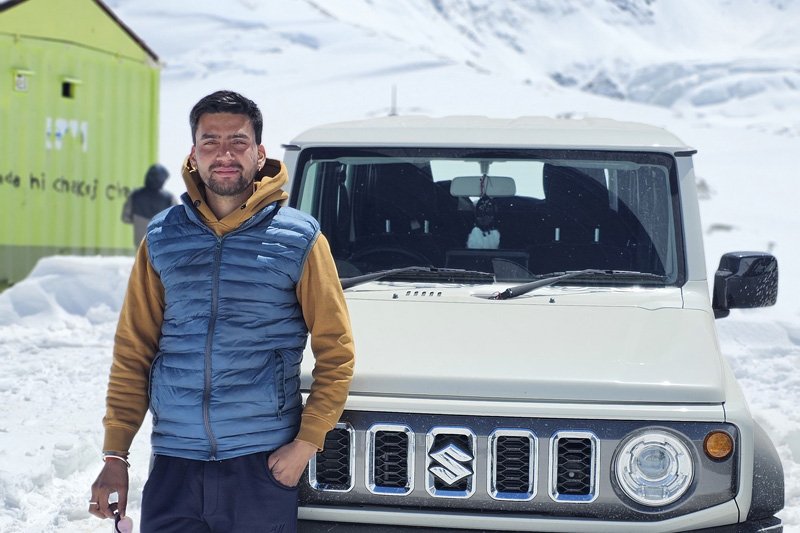 White sedan taxi on a Himachal road